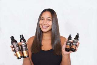 Woman with sleek glass-like silk press styled using Rucker Roots 4 Step Silk Press System