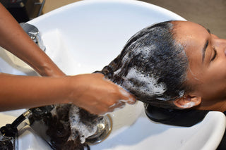 Sulfate-free shampoo and conditioner being used at a professional salon shampoo bowl