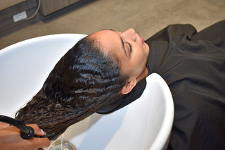 Hair being rinsed after using the sulfate-free shampoo at a salon